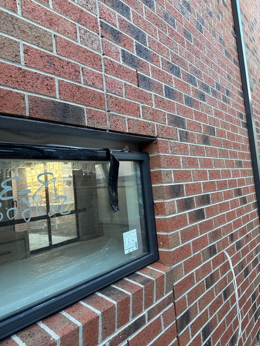 Infills still missing beside and above the window and door frames, found during a fixing inspection in Officer