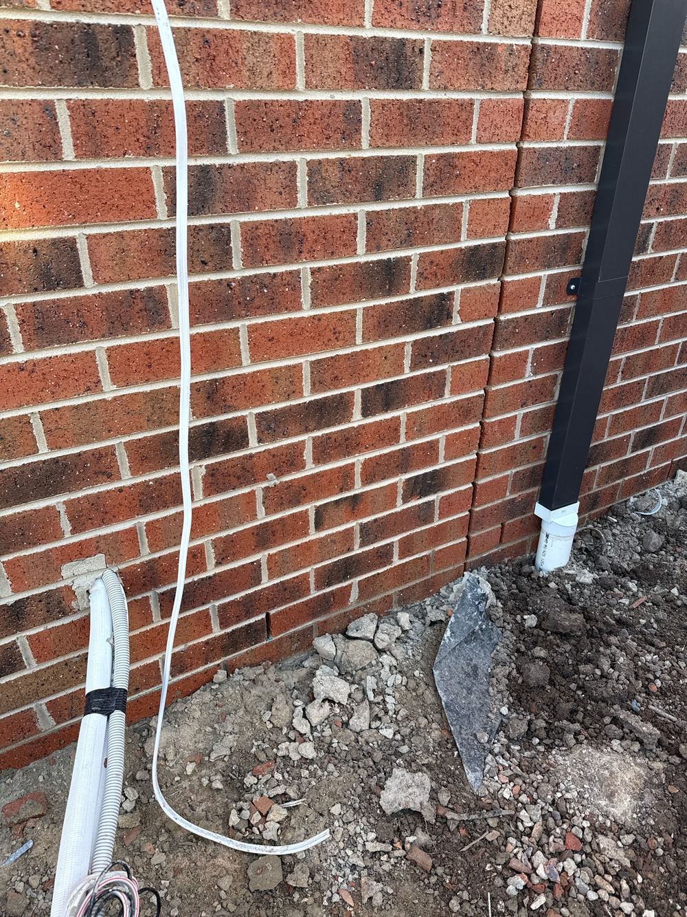Excess mortar and droppings left on the brickwork to be cleaned off, found during a fixing inspection in Officer