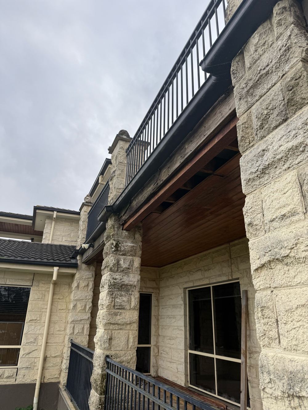 Damaged balcony framing carried on a temporary steel lintel, found during a defect investigation inspection in Officer