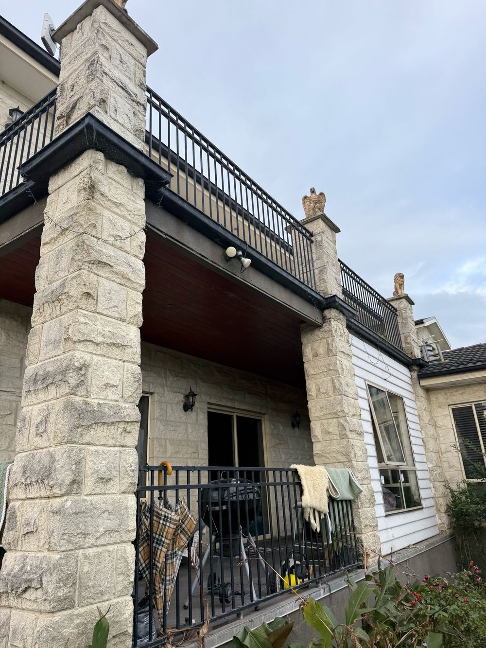 Balcony joists badly damaged, with a steel lintel added as temporary support, found during a defect investigation inspection in Officer