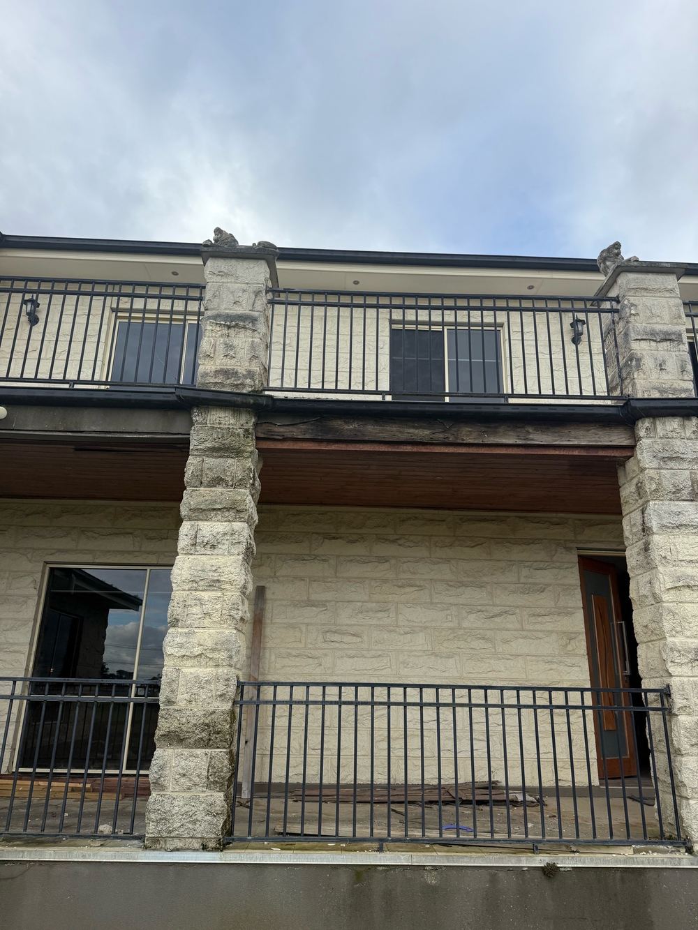 Balustrade anchored into cracked, shifting limestone that can no longer hold it securely, found during a defect investigation inspection in Officer