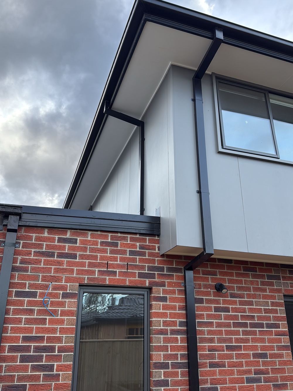 Rear capping flashed with a method unsuited to the junction, risking leaks, found during a pre-handover inspection in Officer