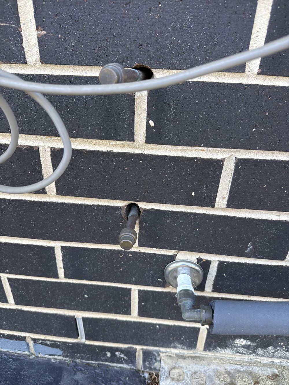 Service penetrations through the brickwork left unsealed against moisture and pests, found during a pre-purchase inspection in Officer
