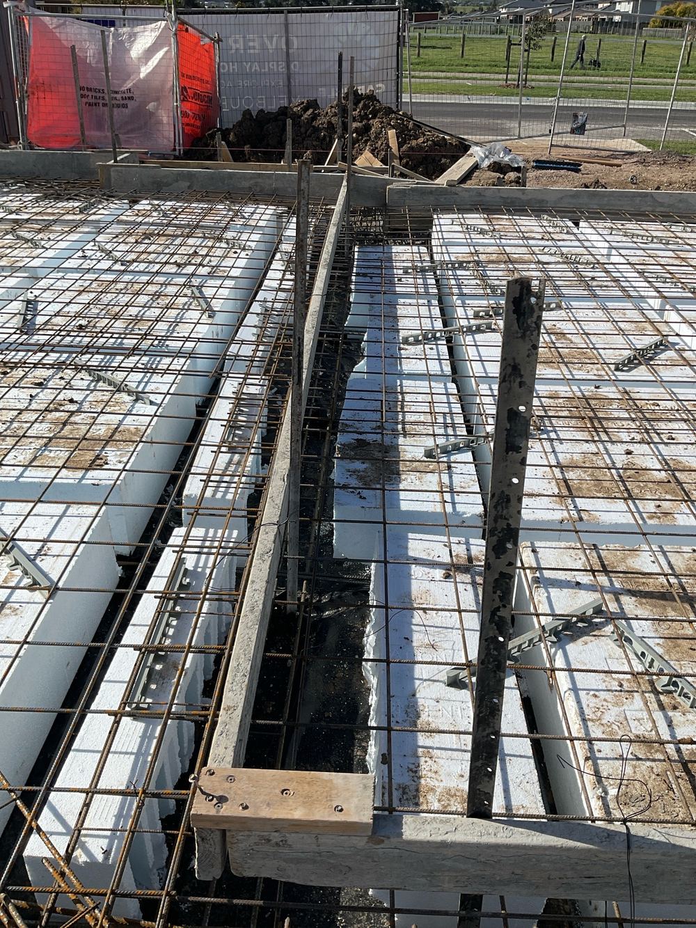 Pods shifted so the beam between them is narrower than the plans require, found during a slab pre-pour inspection in Officer