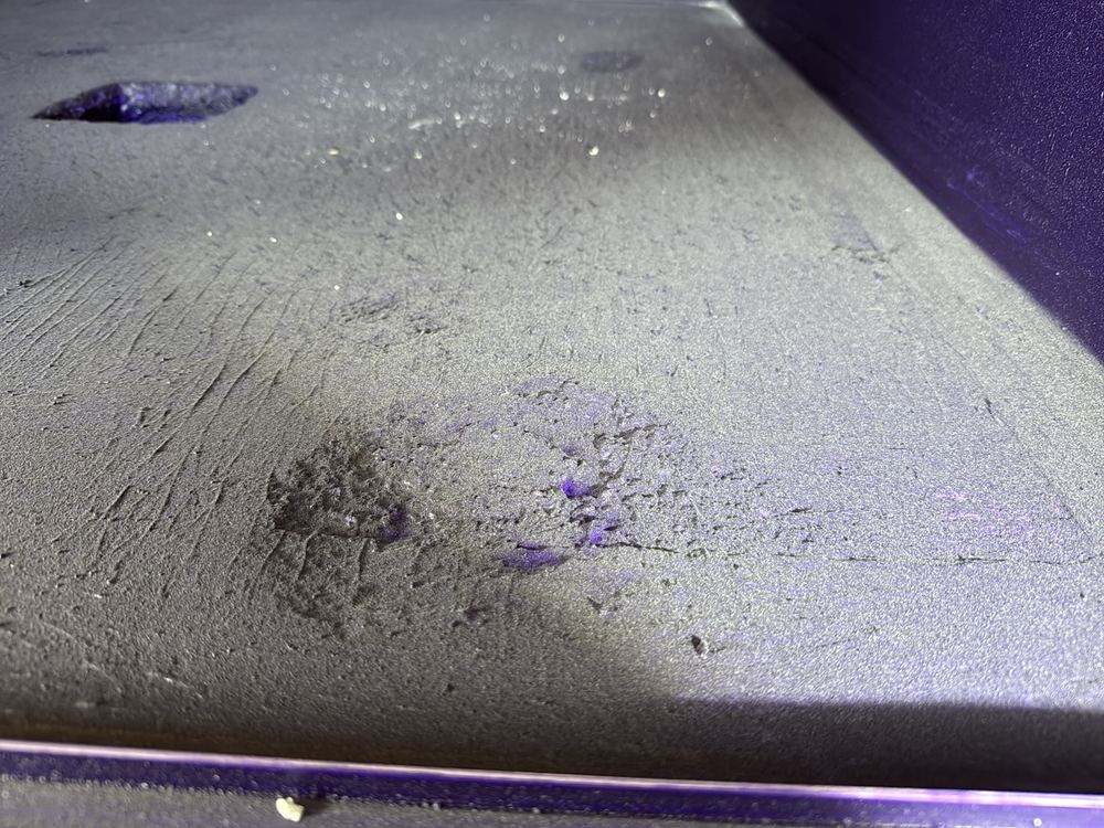 Shower base with low spots where water will sit instead of reaching the waste, found during a waterproofing inspection in Officer