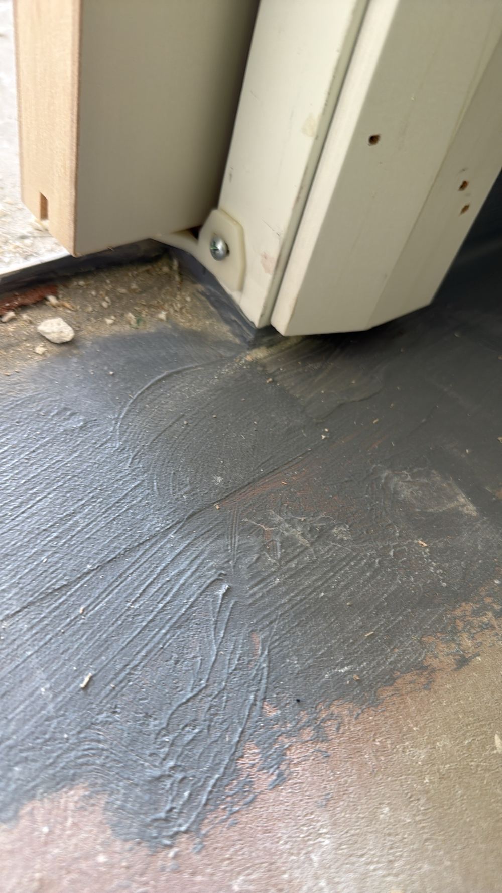 Water stop angle ending short of the wall flashing at the doorway, found during a waterproofing inspection in Officer